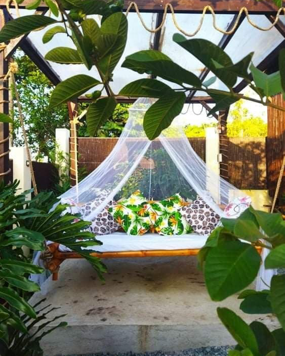 view from garden on gazebo with hanging bed